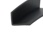 Close-up of a black wood shelf edge with visible grain and a squared corner at the bottom left.