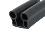 Close-up of a black double-channel rubber extrusion with two circular hollow tubes side by side.