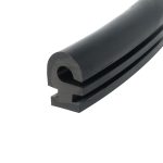 Close-up of a black metal cylindrical tube with a hollow center and rounded end, showing machining marks and a groove along the side.
