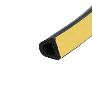 Close-up of a yellow and black striped object viewed diagonally, showing a foam interior and outer yellow surface.
