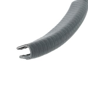 Extreme close-up of a grey zipper along a curved fabric edge, showing the zipper teeth and tape.
