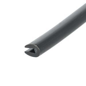 Close-up of a black cylindrical pipe diagonally across a white background, showing a chipped end with a hollow interior.