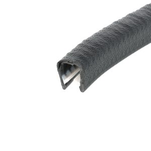 Close-up of a textured black cylindrical object with its end cut open, showing a metal inner core.