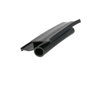 Close-up of a black metal extrusion with a curved channel and sharp edge.