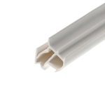 Close-up of a white plastic extrusion with hollow rectangular channels, diagonally oriented across the frame.
