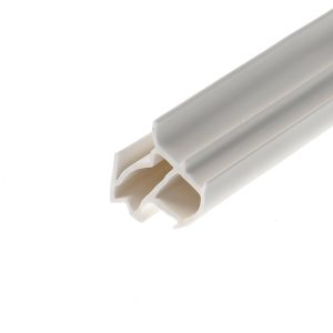 Close-up of a white plastic extrusion with hollow rectangular channels, diagonally oriented across the frame.