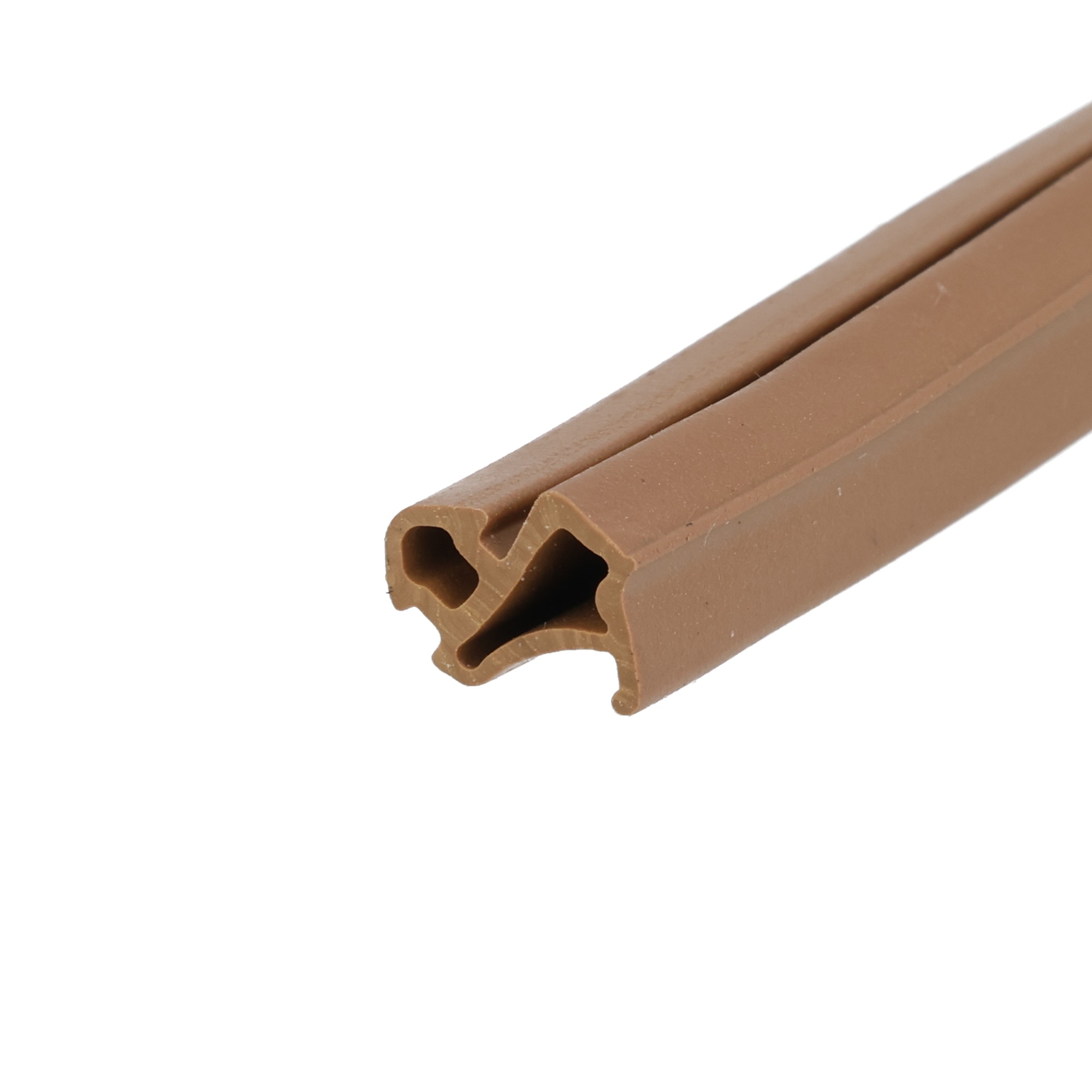 uszczelka-do-okien-epdm-pcv-s-1127-brazowa-020702-4 - Centrum uszczelek Close-up of brown plastic conduit with hollow channels and rounded ends Read as a cable raceway detail