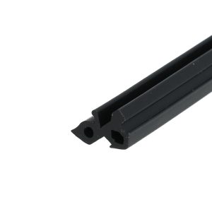 Close-up of a black metal bar with rounded ends and three circular holes, diagonally oriented across the lower right corner.
