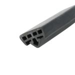 Close-up of a black cordless drill body with vented grip and rectangular cutouts along the side, diagonally oriented in the frame.
