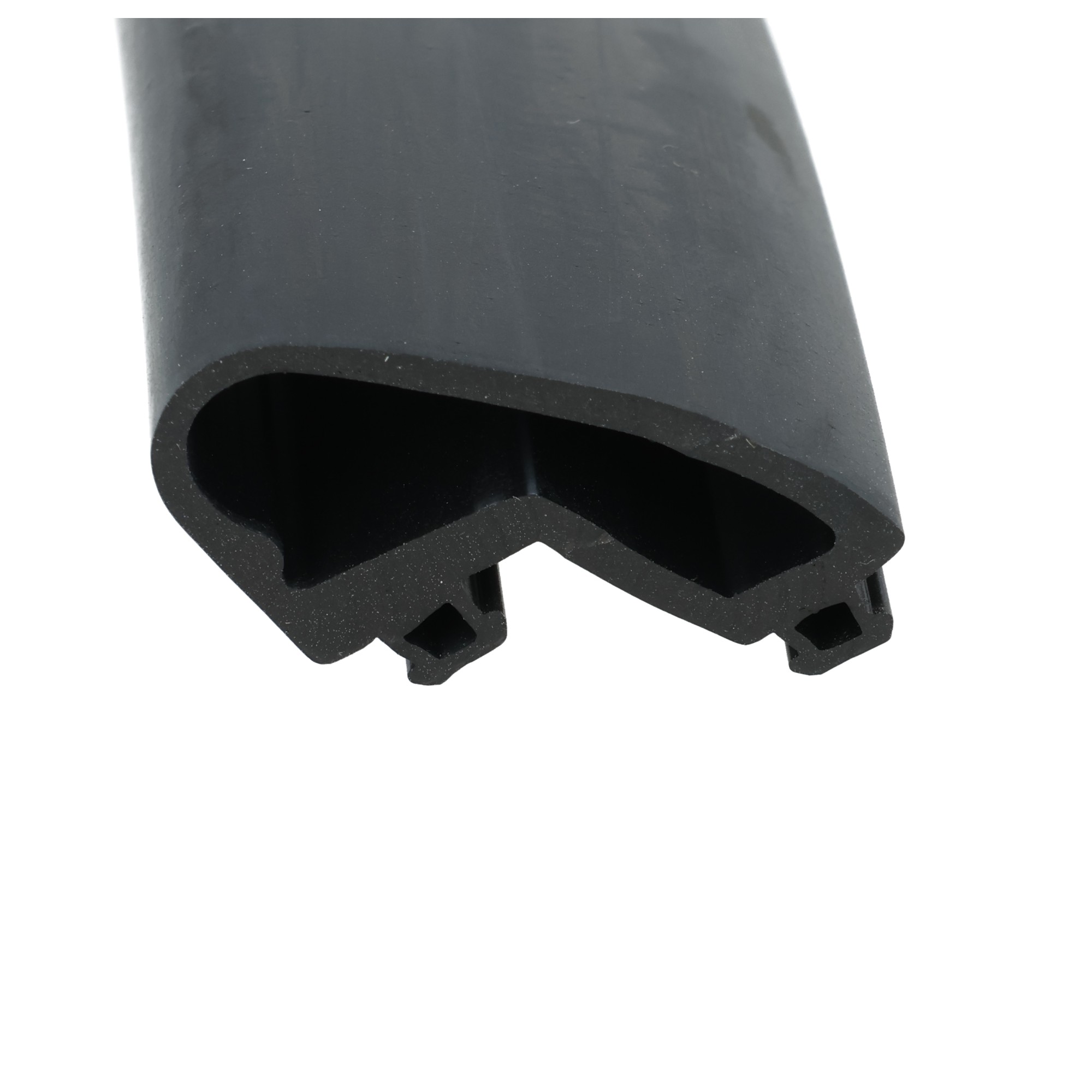 uszczelka-dolna-drzwi-roletowych-wsuwana-gumowa-15-x-25mm-czarna-21-205-1 - Centrum uszczelek Close-up of a dark curved plastic/metal part with rounded cutouts, abstract industrial shape