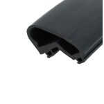 Close-up of a dark gray curved plastic object with a hollow tube cross-section and small cutouts at the edge.