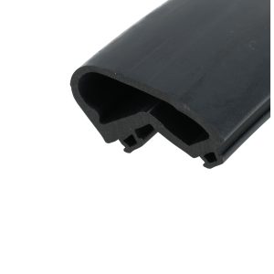 Close-up of a dark gray curved plastic object with a hollow tube cross-section and small cutouts at the edge.