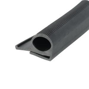 Close-up of a dark gray metal component with a rounded hole and grooved edges along its length.