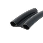 Close-up of two black rubber tubes with circular hollow openings, laid side by side such that their ends are facing the camera.