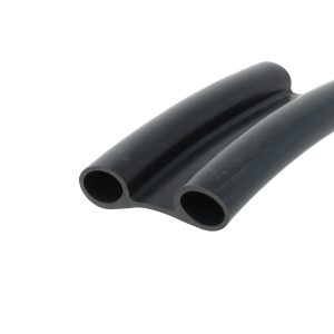 Close-up of two black rubber tubes with circular hollow openings, laid side by side such that their ends are facing the camera.