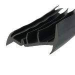 Close-up of black plastic components with curved, comb-like prongs (likely a cable management clip).