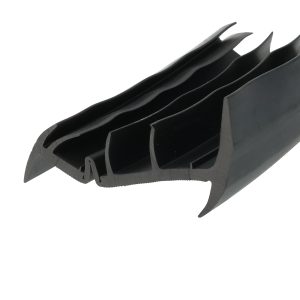 Close-up of black plastic components with curved, comb-like prongs (likely a cable management clip).