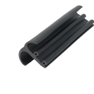 Close-up of a black metal rail with rounded ends and parallel grooves photographed diagonally.