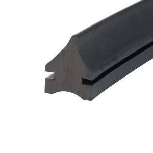 Close-up of a dark matte metal piece with a rounded outer edge and cut-out notch, likely a hardware component detail.