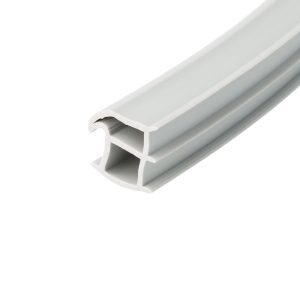 Close-up of a light gray plastic channel extrusion with hollow rectangular openings, viewed diagonally.
