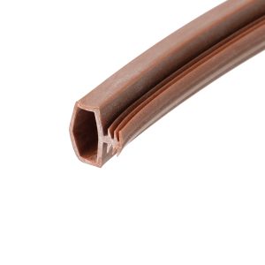 Close-up of a brown plastic extrusion with a hollow rectangular cross-section and ridged outer surface, shown diagonally along the image edge
