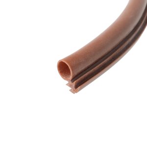 Close-up of a curved brown hollow tube with ridged edges, diagonally positioned against a white background.
