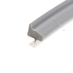 Close-up of a curved piece of foam insulation with a gray textured outer shell and a porous beige interior seen at the cut end.
