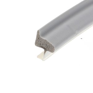 Close-up of a curved piece of foam insulation with a gray textured outer shell and a porous beige interior seen at the cut end.