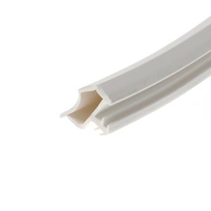 Close-up of white curved trim or molding with a beveled edge and soft diagonal shadowed area along the right side.