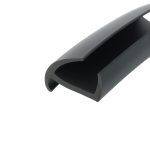 Close-up of a black plastic clip or clamp with a rounded inner channel, viewed at an angle.