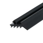 Close-up of a black metal tool with jagged teeth along the bottom edge, diagonally oriented in the frame.