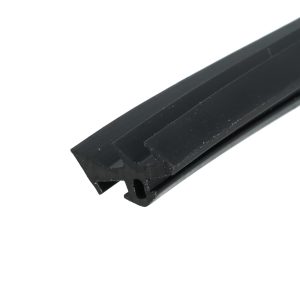 Close-up of a black, grooved metal/plastic extrusion at a diagonal angle, showing grooves and a notch at the end (no context).