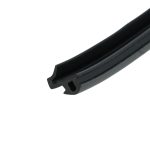 Close-up of a black grooved plastic rail angled diagonally across the frame.