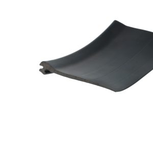 Close-up of the curved edge of a dark, matte surface against a white background.