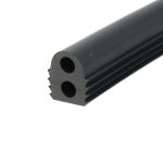 Close-up of a dark cylindrical rod with a circular hollow bore and grooved edge, angled diagonally across the frame.