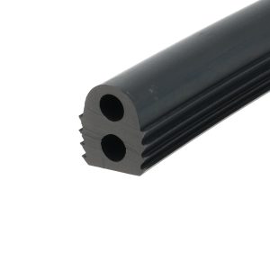 Close-up of a dark cylindrical rod with a circular hollow bore and grooved edge, angled diagonally across the frame.