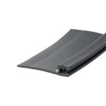 Close-up of a black rubber stair tread with a ridged edge, showing grooves at the right side.