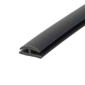Close-up of a black curved metal rail diagonally across a white background, showing a rounded edge and slight texture.