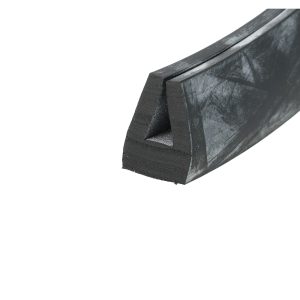 Close-up of a black textured metal bracket or beam viewed obliquely, showing a hollow triangular slot and rough surface.