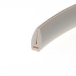 Close-up of a white curved plastic corner with a beige inner edge, set against a white background.