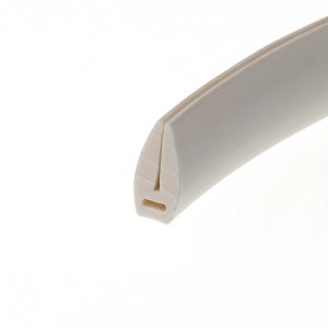 Close-up of a white curved cardboard edge with a beige seam at the corner.