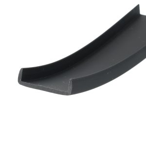 Close-up of a black curved edge with a squared, beveled tip against a white background, showing a matte surface and slight wear.