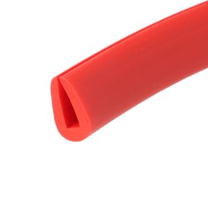 Close-up of a bright red plastic cylindrical object with a seam along its length and rounded end edge
