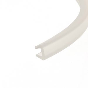 Close-up of a white circular dish edge with a beige background, abstract and soft-edged.