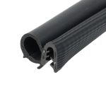 Close-up of a black foam rubber tube with a round hollow center and ribbed exterior profile, likely a seal or insulation tubing.