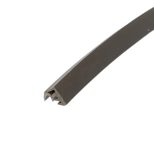 Close-up of a dark metal cutting tool tip with multiple triangular teeth against a white background, oriented diagonally across the image.