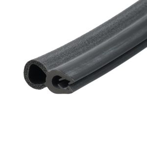 Close-up of a black foam-tube gasket with a hollow center and porous interior, showing its circular cross-section.