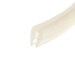 Close-up of a pale beige curved plastic object with round cutouts on the right side of a white background.