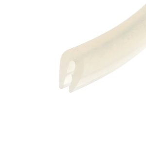 Close-up of a pale beige curved plastic object with round cutouts on the right side of a white background.
