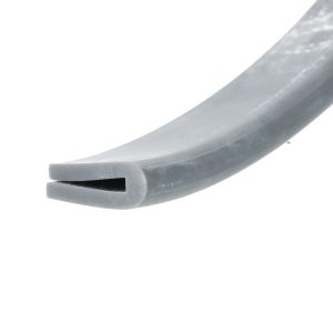 Close-up of a gray, curved plastic tool with a rectangular slot at the tip against a white background.